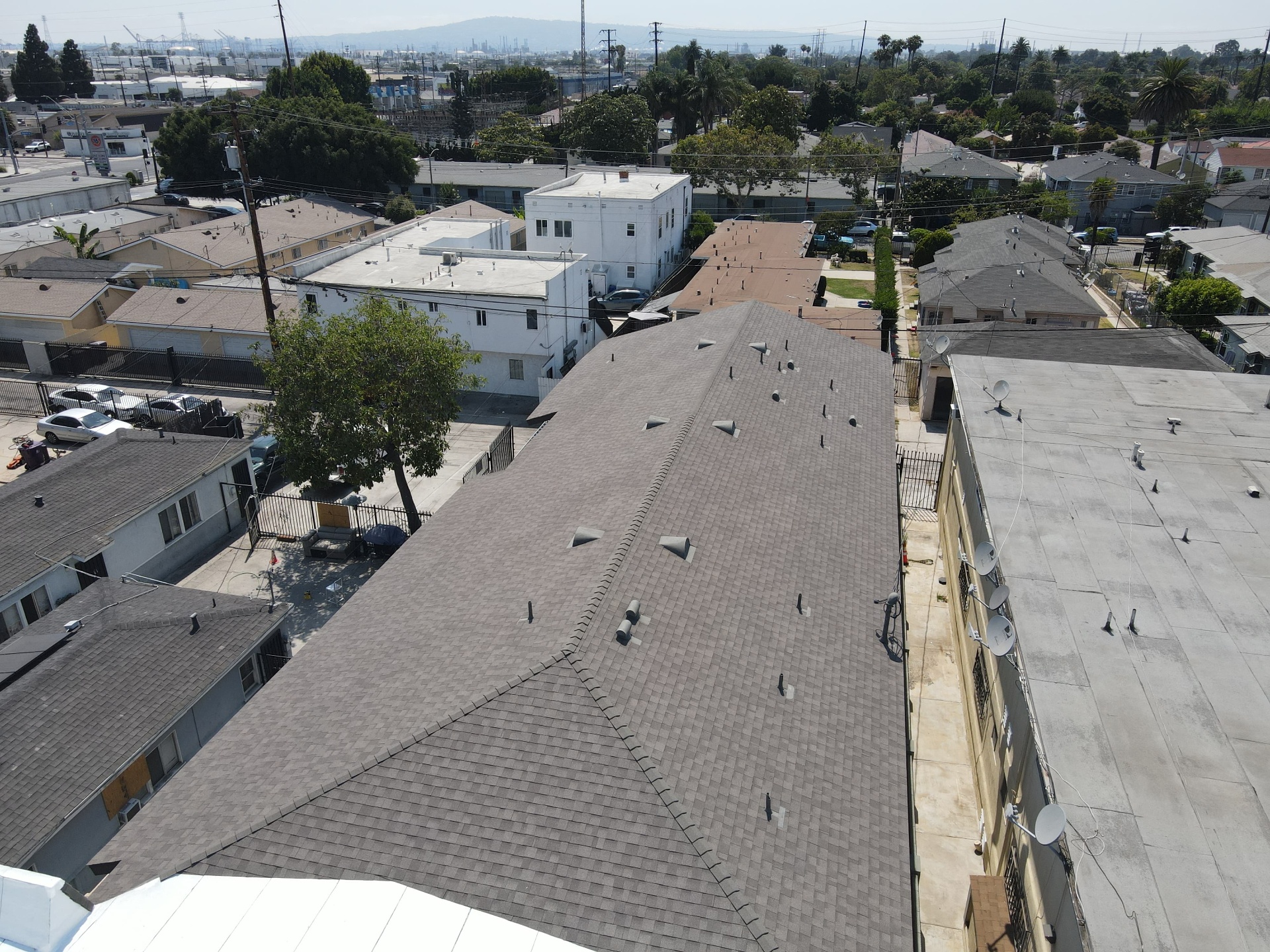 Aerial view of completed shingle roof on multi-unit apartment building