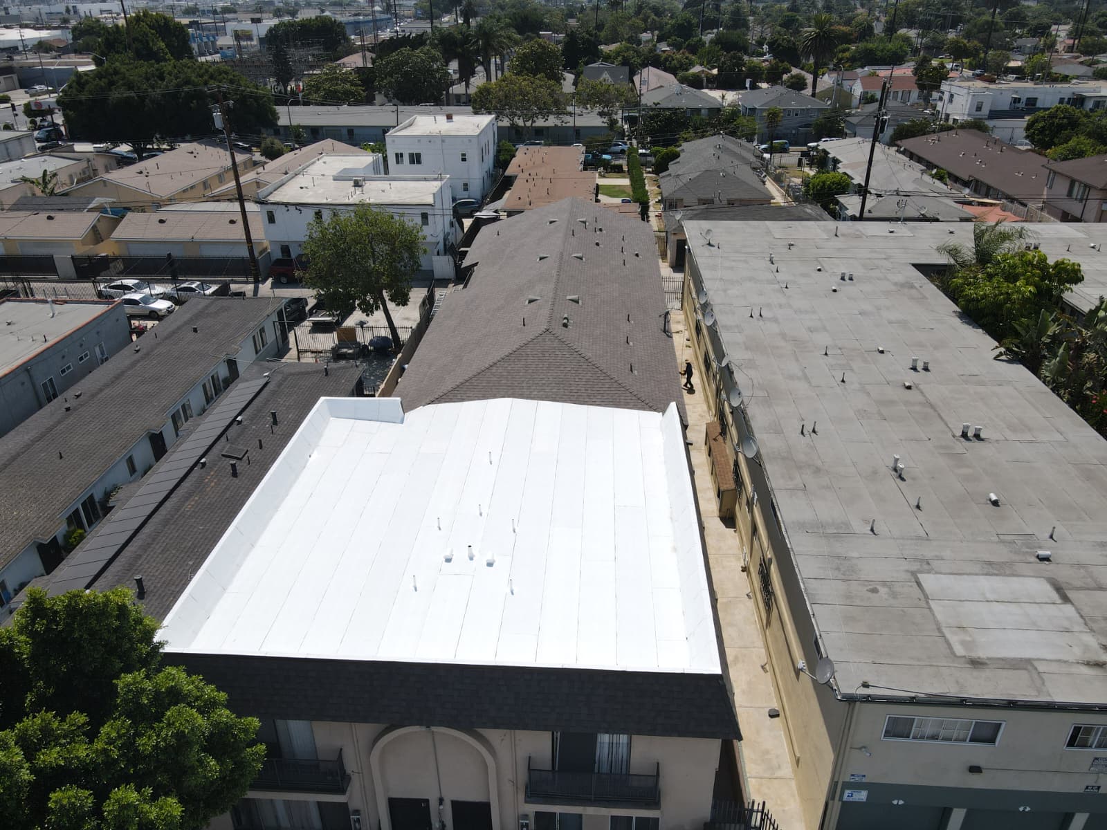 Newly installed white reflective flat roof on apartment building