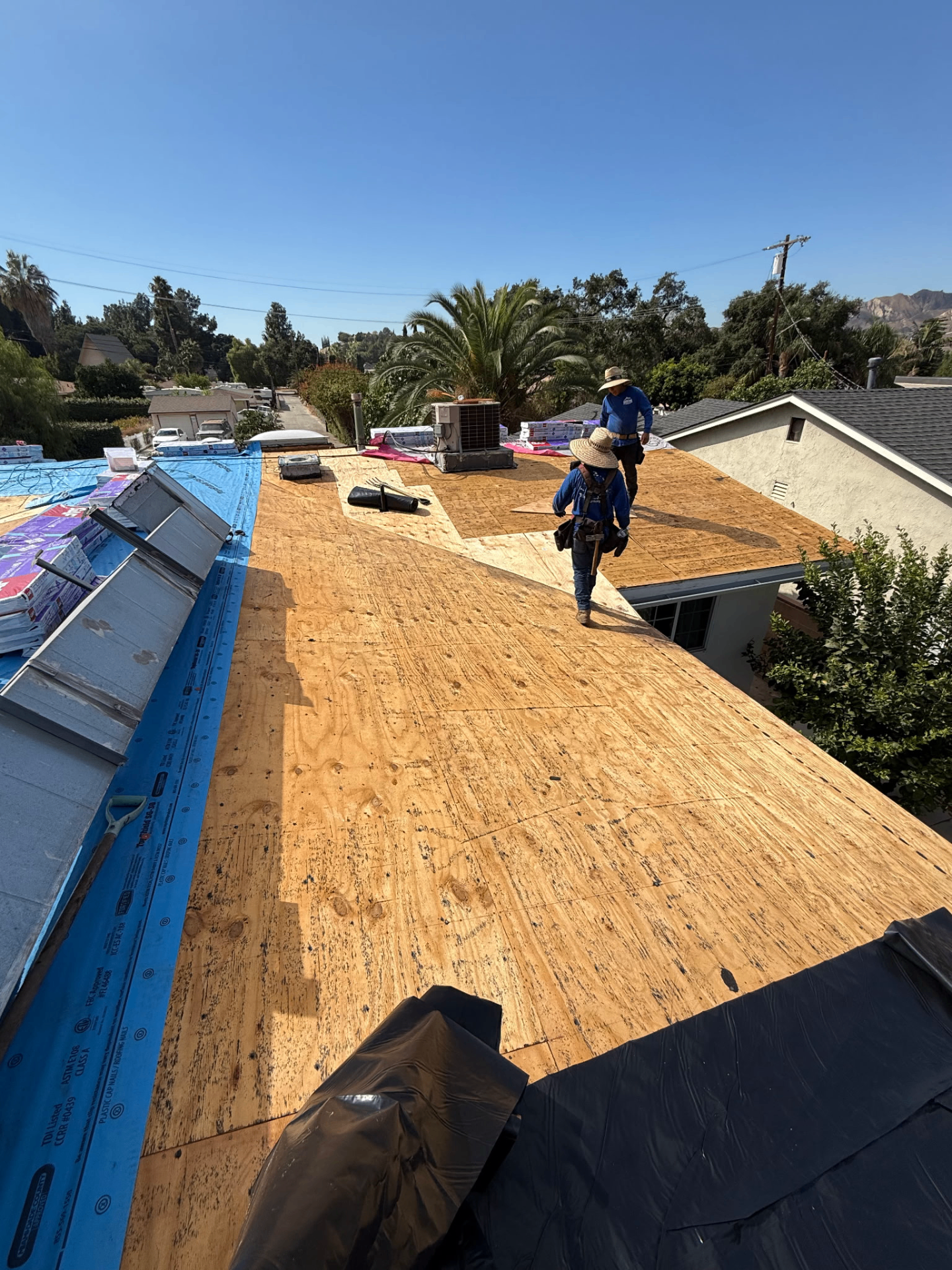 Fresh plywood sheathing installed on a residential roof